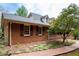 Brick home with a side view showcasing the garage and landscaping at 1827 Lost Mountain Rd, Powder Springs, GA 30127