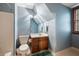 Small bathroom with single vanity, shower/tub combo, and wood cabinet at 1827 Lost Mountain Rd, Powder Springs, GA 30127