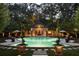Inviting kidney-shaped pool with a charming pool house and lush landscaping at 4665 Riverview Rd, Atlanta, GA 30327