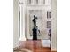 Elegant entryway with a large mirror, statue, and hardwood floors at 4665 Riverview Rd, Atlanta, GA 30327