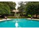 Large, kidney-shaped pool with a view of the house at 4665 Riverview Rd, Atlanta, GA 30327