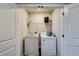 Convenient laundry room with washer, dryer, and storage shelves at 1025 Fable Ln, Hampton, GA 30228