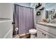 Clean bathroom with granite vanity and gray shower curtain at 1025 Fable Ln, Hampton, GA 30228