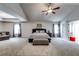 Spacious main bedroom with high ceilings, plush carpeting, and an en-suite bathroom at 1025 Fable Ln, Hampton, GA 30228