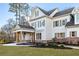 Side view of a white farmhouse with gray shutters, brick accents, and a covered porch at 76 Telfair Ct, Acworth, GA 30101