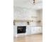 Modern fireplace with white stone and wood mantel, flanked by built-in shelving and cabinets at 76 Telfair Ct, Acworth, GA 30101