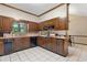 Kitchen with dark wood cabinets, granite counters, and black appliances at 4513 Rivercliff Sw Dr, Lilburn, GA 30047