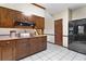 Kitchen features wood cabinets, gas cooktop, and black refrigerator at 4513 Rivercliff Sw Dr, Lilburn, GA 30047