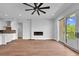 Open living space with hardwood floors, fireplace, and balcony access at 8212 Main St # 1202, Woodstock, GA 30188