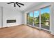 Hardwood floors, fireplace, and sliding doors to a private balcony at 8212 Main St # 1202, Woodstock, GA 30188
