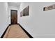 Clean and bright hallway with dark trim and wood flooring at 8212 Main St # 1202, Woodstock, GA 30188
