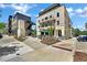 Street view of modern commercial buildings and outdoor seating areas at 8212 Main St # 1202, Woodstock, GA 30188