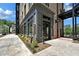 Building exterior showcasing a modern design with brick and large windows at 8212 Main St # 1202, Woodstock, GA 30188