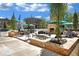 Outdoor patio area with seating, fire pit, and landscaping at 8212 Main St # 1202, Woodstock, GA 30188
