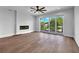Spacious living room with hardwood floors, fireplace, and access to balcony at 8212 Main St # 1202, Woodstock, GA 30188