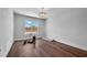 Bright bedroom with hardwood floors and large window at 8212 Main St # 1202, Woodstock, GA 30188