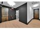 Modern hallway with elevator access and dark accent wall at 8212 Main St # 1202, Woodstock, GA 30188