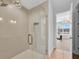 Spa-like bathroom with herringbone tile shower and glass enclosure at 8212 Main St # 1202, Woodstock, GA 30188