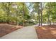 Long driveway leading to a charming house nestled in a wooded setting at 1199 Old Lathemtown Rd, Canton, GA 30115