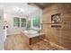 Spa-like bathroom with glass shower, soaking tub, and wood-like tile at 1199 Old Lathemtown Rd, Canton, GA 30115