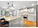 Kitchen boasts a large island, white cabinets and hardwood floors at 1199 Old Lathemtown Rd, Canton, GA 30115