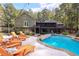 Expansive pool and patio area with lounge chairs; home view at 1199 Old Lathemtown Rd, Canton, GA 30115