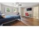 Bright bedroom with wood floors, a built-in desk, and access to a bathroom at 1199 Old Lathemtown Rd, Canton, GA 30115
