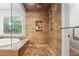 Large walk-in shower with pebble floor and wood-look tile at 1199 Old Lathemtown Rd, Canton, GA 30115
