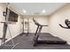 Basement home gym with treadmill, weight machine and vertical climber at 1199 Old Lathemtown Rd, Canton, GA 30115