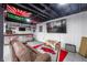 Finished basement with bar, lounge area, and large TV at 1199 Old Lathemtown Rd, Canton, GA 30115