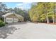 Large concrete driveway with three-car garage at 1199 Old Lathemtown Rd, Canton, GA 30115
