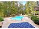 Inviting kidney-shaped pool surrounded by lush landscaping at 1199 Old Lathemtown Rd, Canton, GA 30115