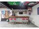 Basement bar with a rustic wooden countertop and red stools at 1199 Old Lathemtown Rd, Canton, GA 30115