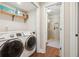Convenient laundry room with washer, dryer, and shelving at 1199 Old Lathemtown Rd, Canton, GA 30115