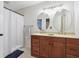 Bathroom with double vanity, large mirrors and shower/tub combo at 1199 Old Lathemtown Rd, Canton, GA 30115