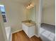 White vanity with granite countertop and wood-look flooring at 1345 Labonte Pkwy, Mcdonough, GA 30253