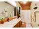 Clean bathroom with a bathtub and wood vanity at 1785 Whitley Rd, Dacula, GA 30019