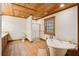 Bathroom with a clawfoot tub, walk-in shower, and wood cabinets at 1785 Whitley Rd, Dacula, GA 30019