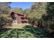 Log home exterior with a wrap-around deck and wooded backyard at 1785 Whitley Rd, Dacula, GA 30019