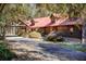 Log home with red metal roof and covered entryway at 1785 Whitley Rd, Dacula, GA 30019