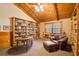 Cozy library with built-in bookshelves, comfortable seating, and a round table at 1785 Whitley Rd, Dacula, GA 30019
