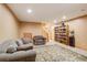 Comfortable basement sitting area with couches and a built-in bookcase at 1785 Whitley Rd, Dacula, GA 30019