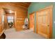 Lighted hallway with wood walls and a full bath at 1785 Whitley Rd, Dacula, GA 30019