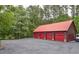 Four-car garage with red doors and a spacious parking area at 1785 Whitley Rd, Dacula, GA 30019