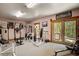 Well-equipped home gym with various exercise machines and access to the outdoors at 1785 Whitley Rd, Dacula, GA 30019