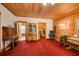 Spacious bedroom with wood-paneled walls, walk-in closet, and red carpet at 1785 Whitley Rd, Dacula, GA 30019