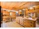 Open concept kitchen with wood cabinetry, island, and dining area at 1785 Whitley Rd, Dacula, GA 30019