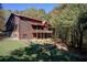 Two story log home with red roof and landscaped yard at 1785 Whitley Rd, Dacula, GA 30019
