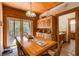 Dining area with wood table and chairs, built-in hutch, and access to deck at 1785 Whitley Rd, Dacula, GA 30019
