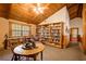 Charming library featuring built-in bookshelves, a reading chair and a wooden table at 1785 Whitley Rd, Dacula, GA 30019